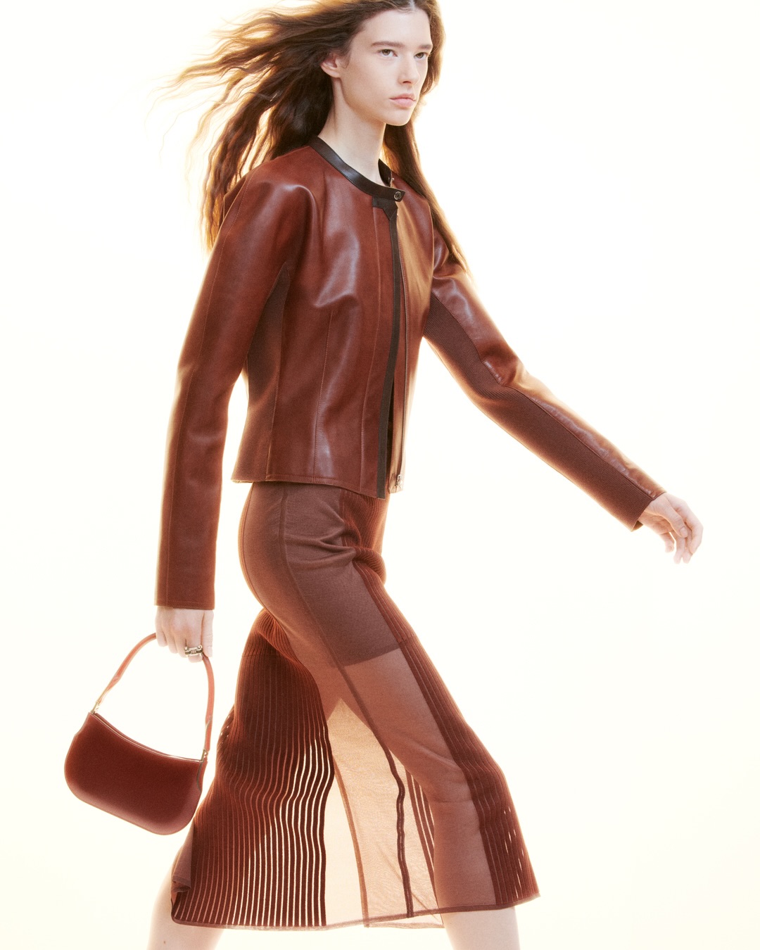 Model showcasing movement of minimalist garment with floating fabric elements
