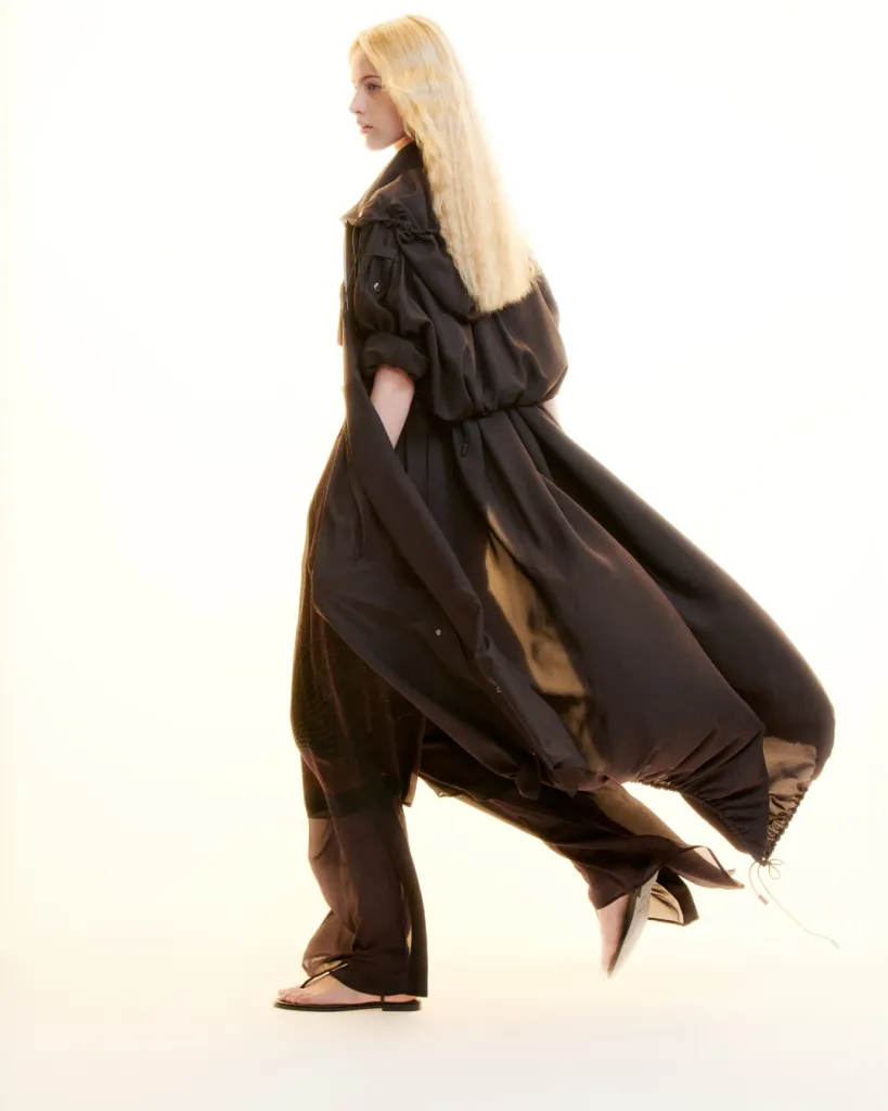 Detail of delicately constructed neckline and shoulder seam on minimalist white dress