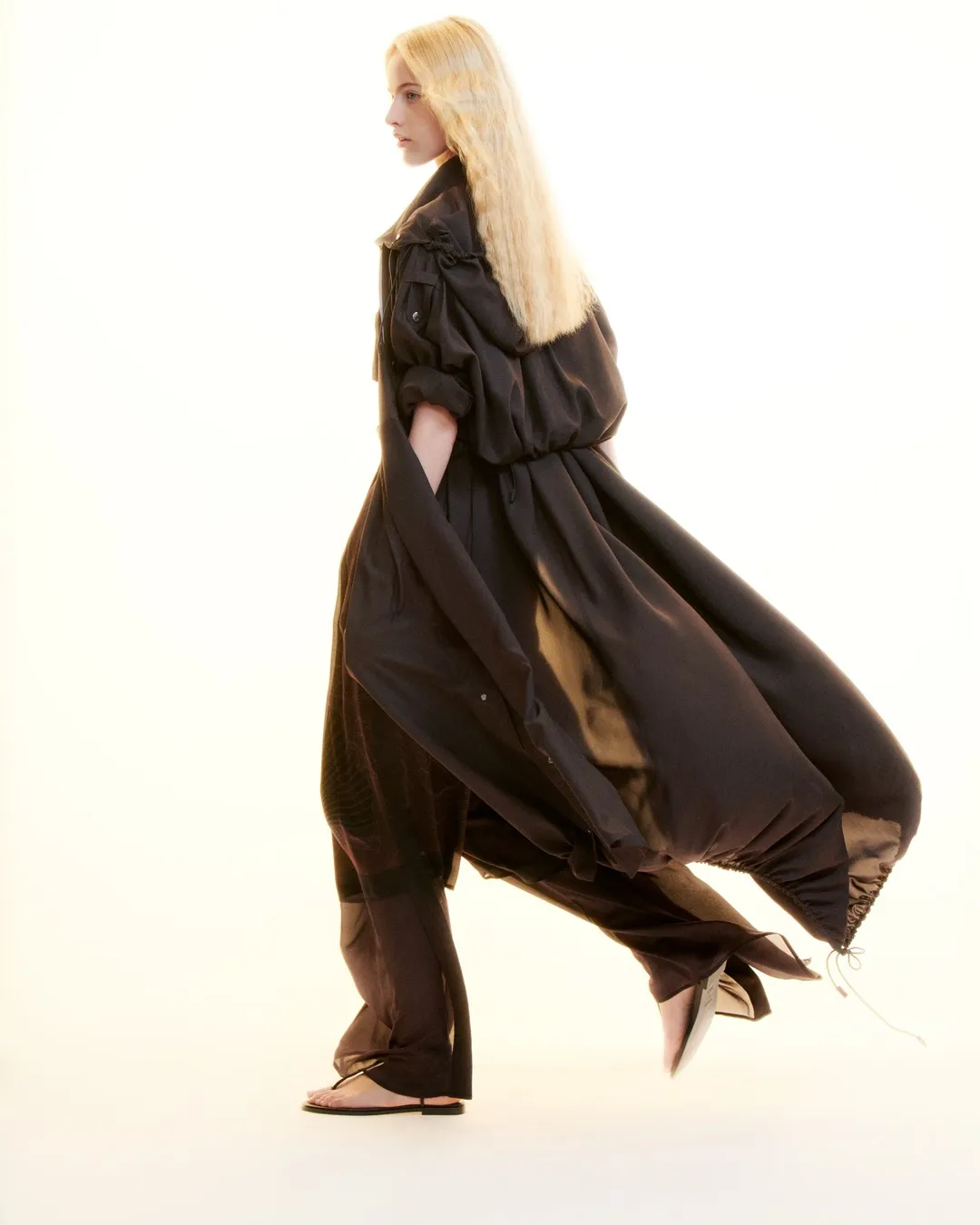 Detail of delicately constructed neckline and shoulder seam on minimalist white dress