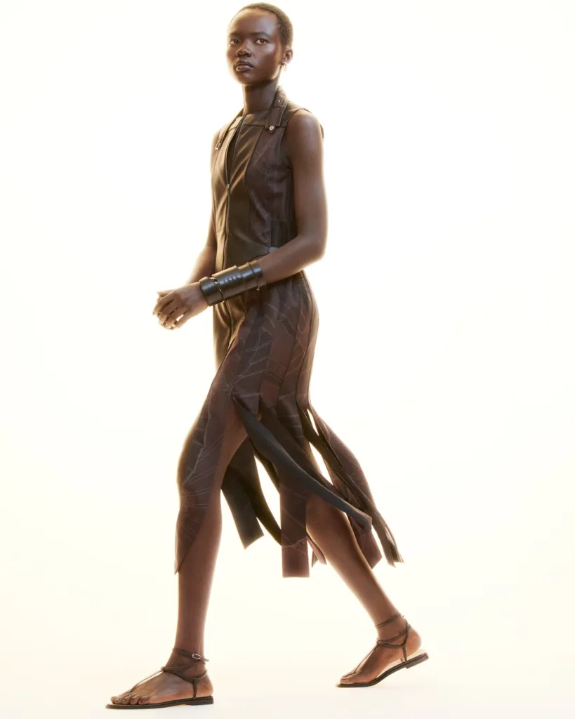 Model in motion wearing structured yet ethereal tailored jacket with precisely positioned vent details