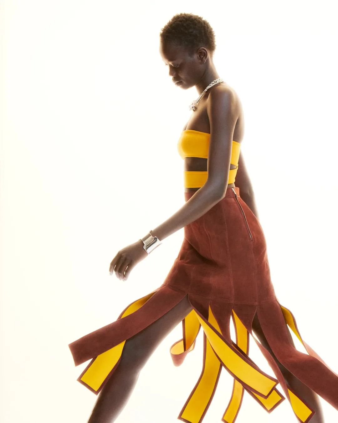Model wearing flowing draped garment from Hermès Spring-Summer 2027 collection, demonstrating ethereal silhouette and movement