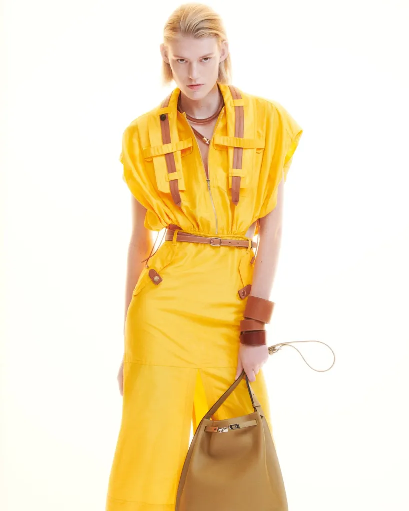 Detail of elegant tailored piece with lifted hem and considered proportions, showcasing Hermès craftsmanship