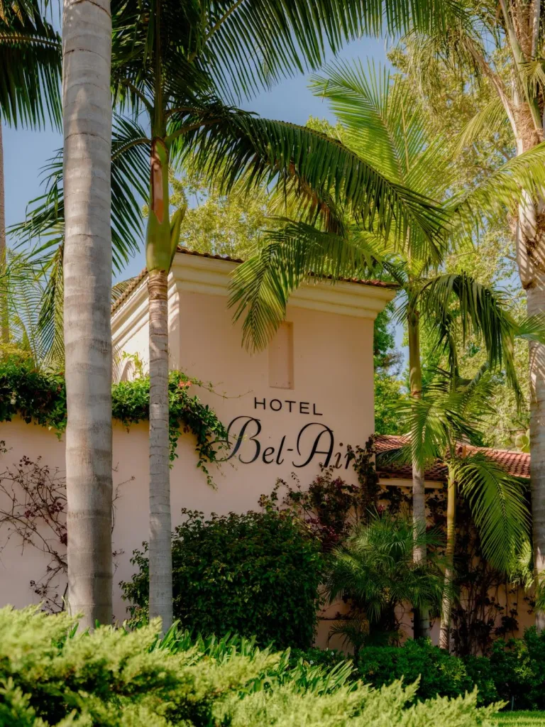 Hotel Bel-Air's signature pink bungalow nestled among towering palms and manicured gardens in the canyons of Bel-Air
