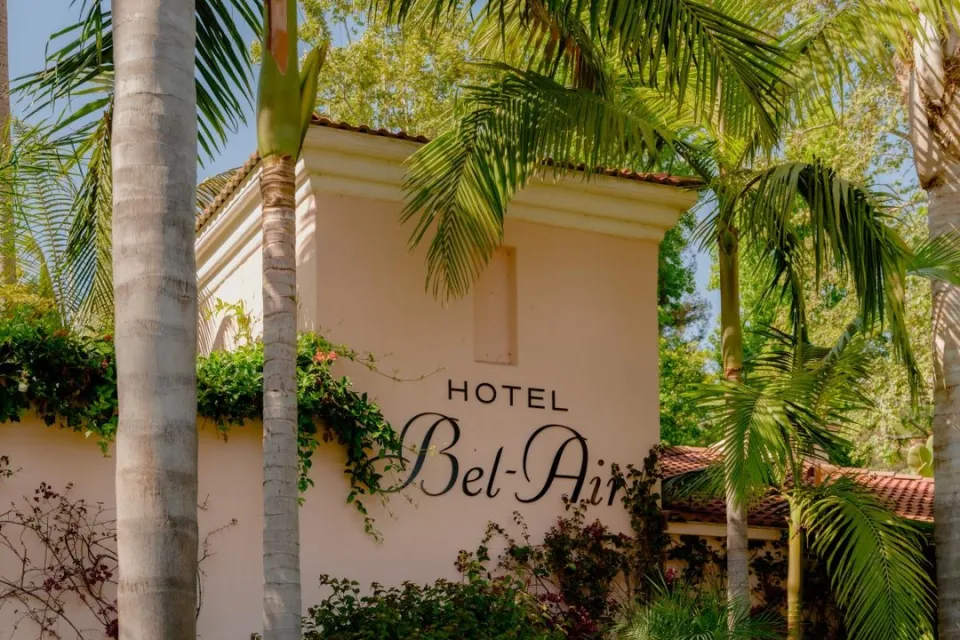 Hotel Bel-Air's signature pink bungalow nestled among towering palms and manicured gardens in the canyons of Bel-Air
