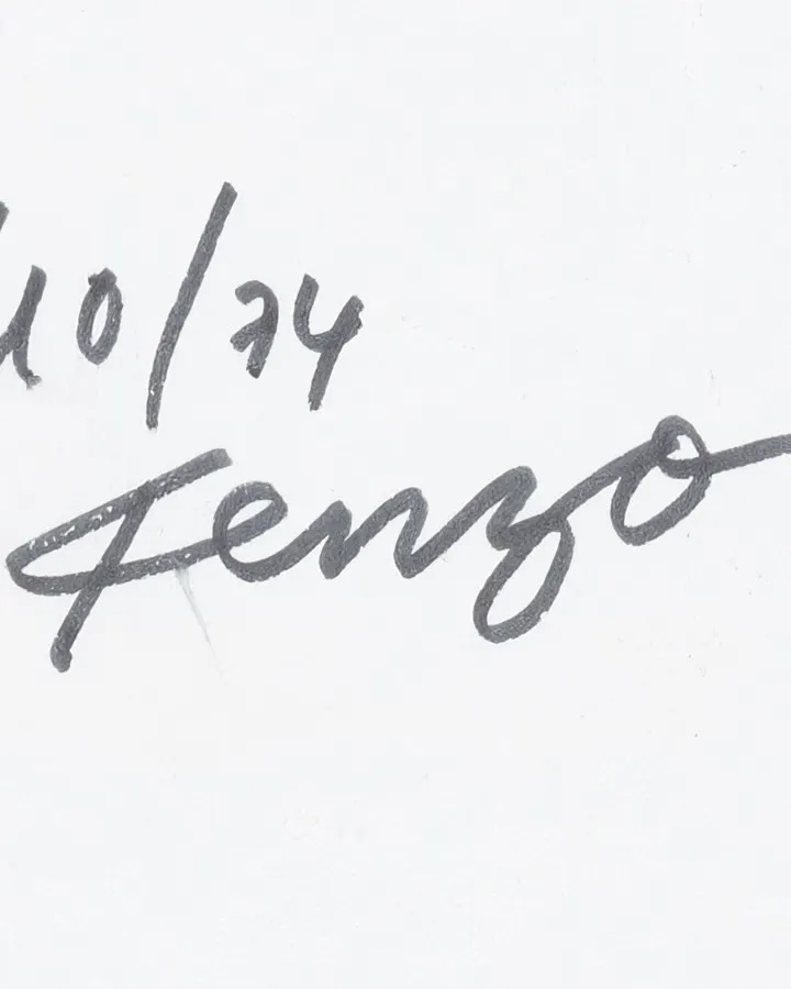 Model wearing Kenzo FW26 collection featuring printed founder signatures