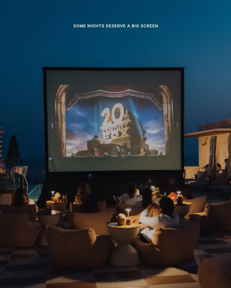 Open air cinema screening at Escondido with guests seated beneath starlit sky