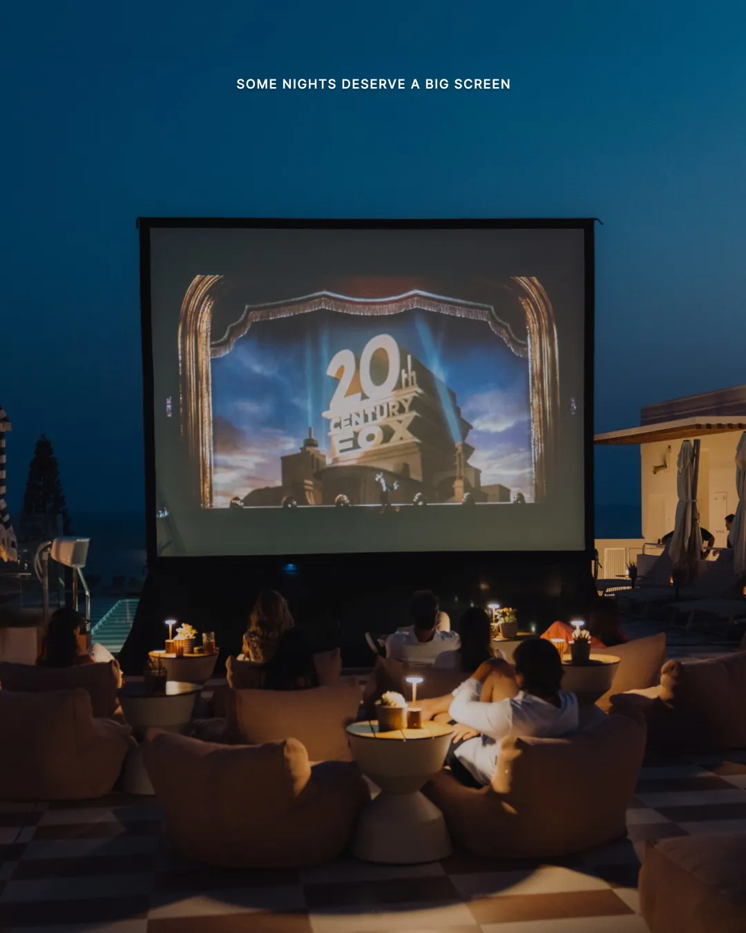 Open air cinema screening at Escondido with guests seated beneath starlit sky