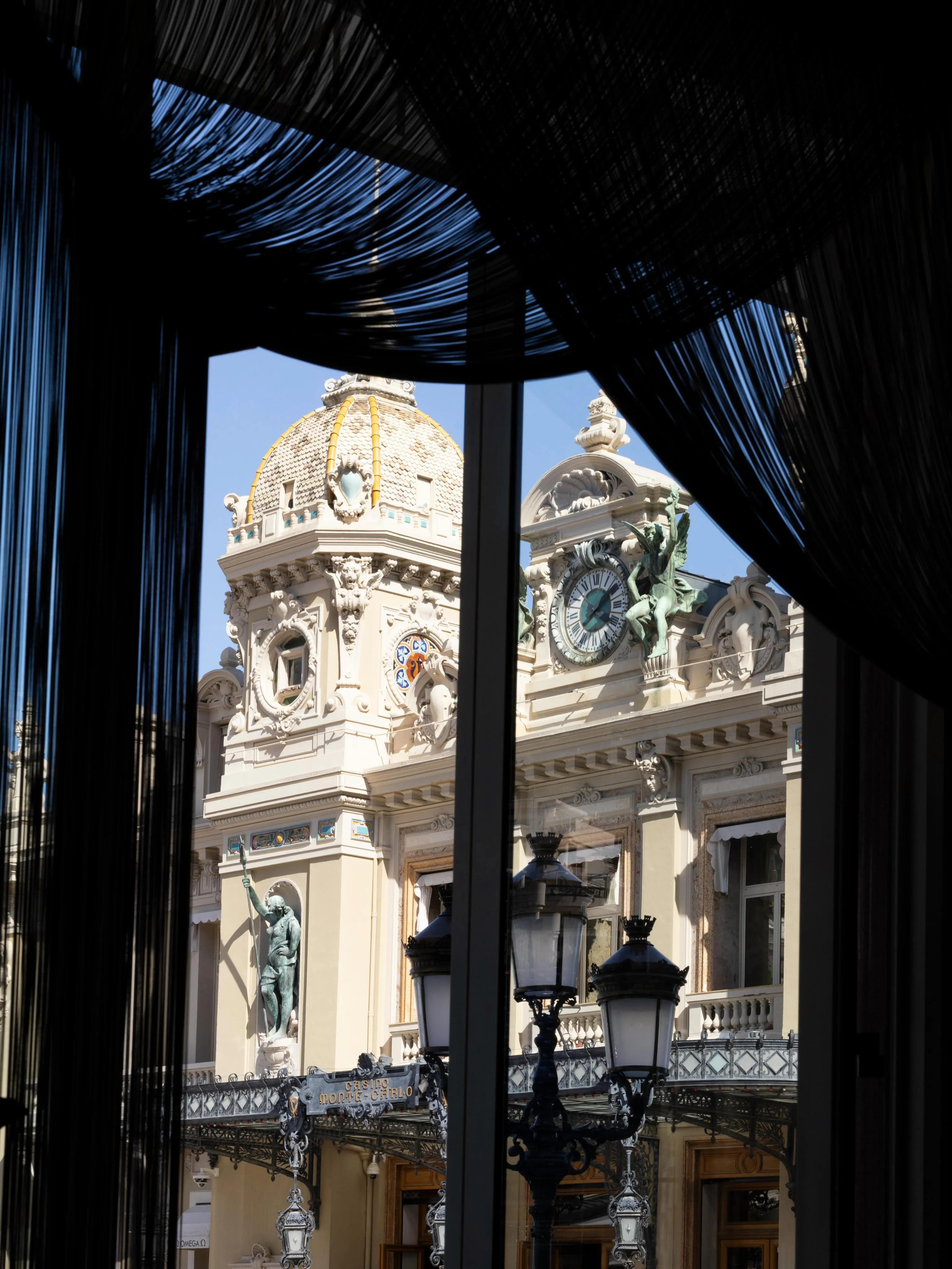 The dining space at Le Louis XV – Alain Ducasse with refined lighting and proportions reflecting the designers' vision of contemporary luxury