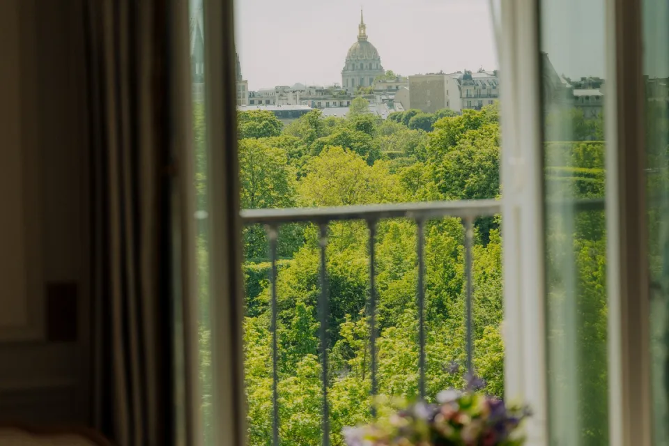 Le Meurice Paris suite with breakfast service overlooking Tuileries Gardens and morning light