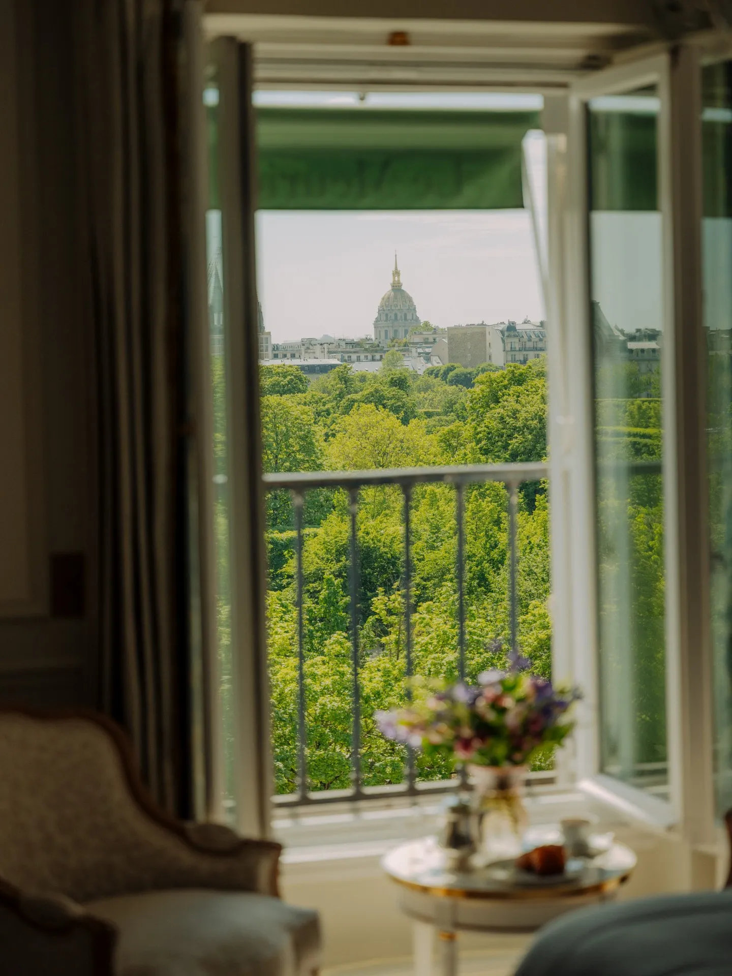 Le Meurice Paris suite with breakfast service overlooking Tuileries Gardens and morning light