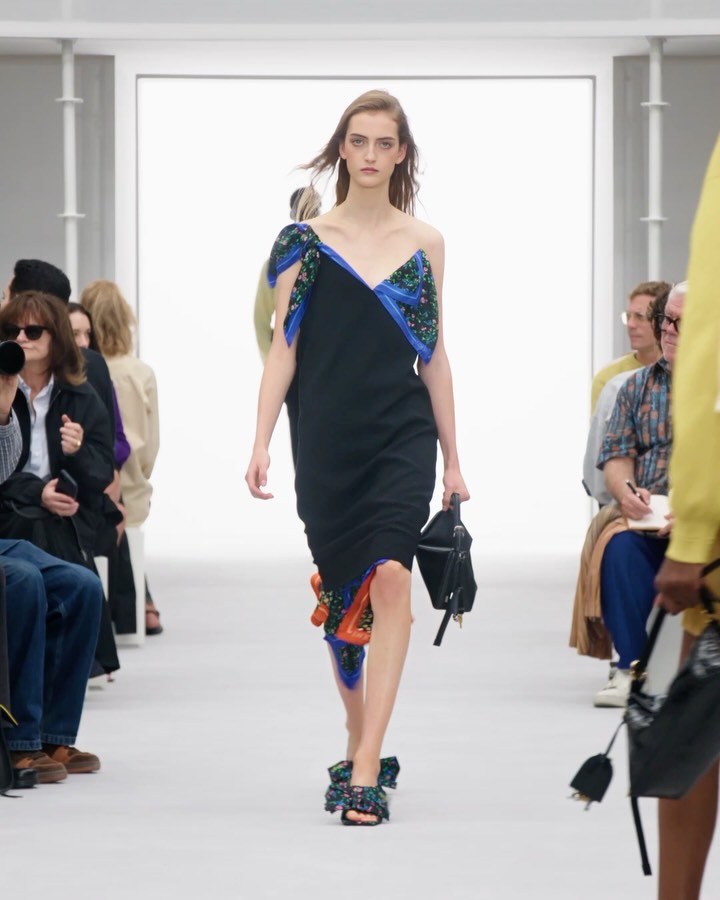 Model wearing taleguilla-style trousers with floral satin scarf detail