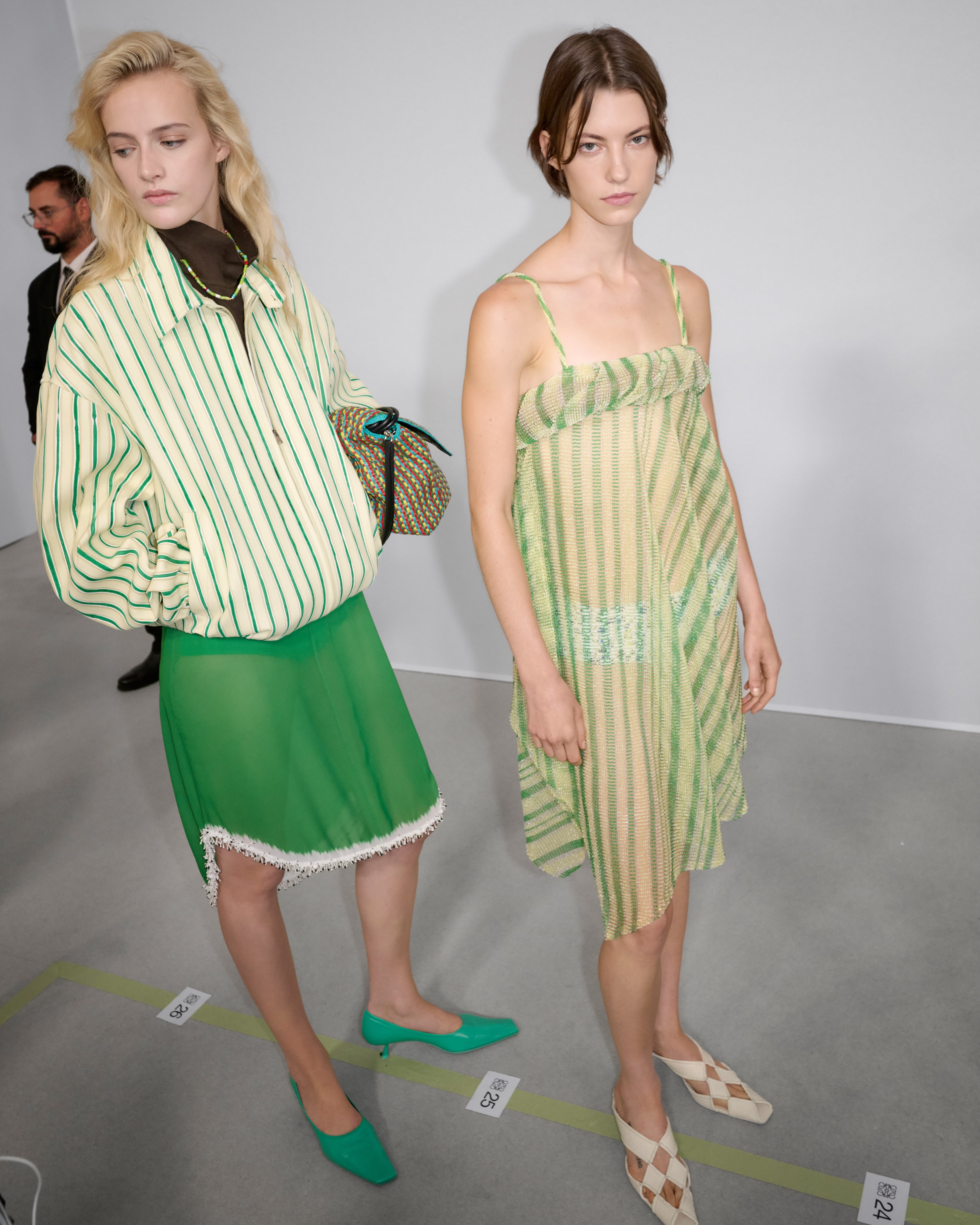 A full-length view of a model in a glass bead dress, showing how the garment moves and creates shadows and luminescence with body movement
