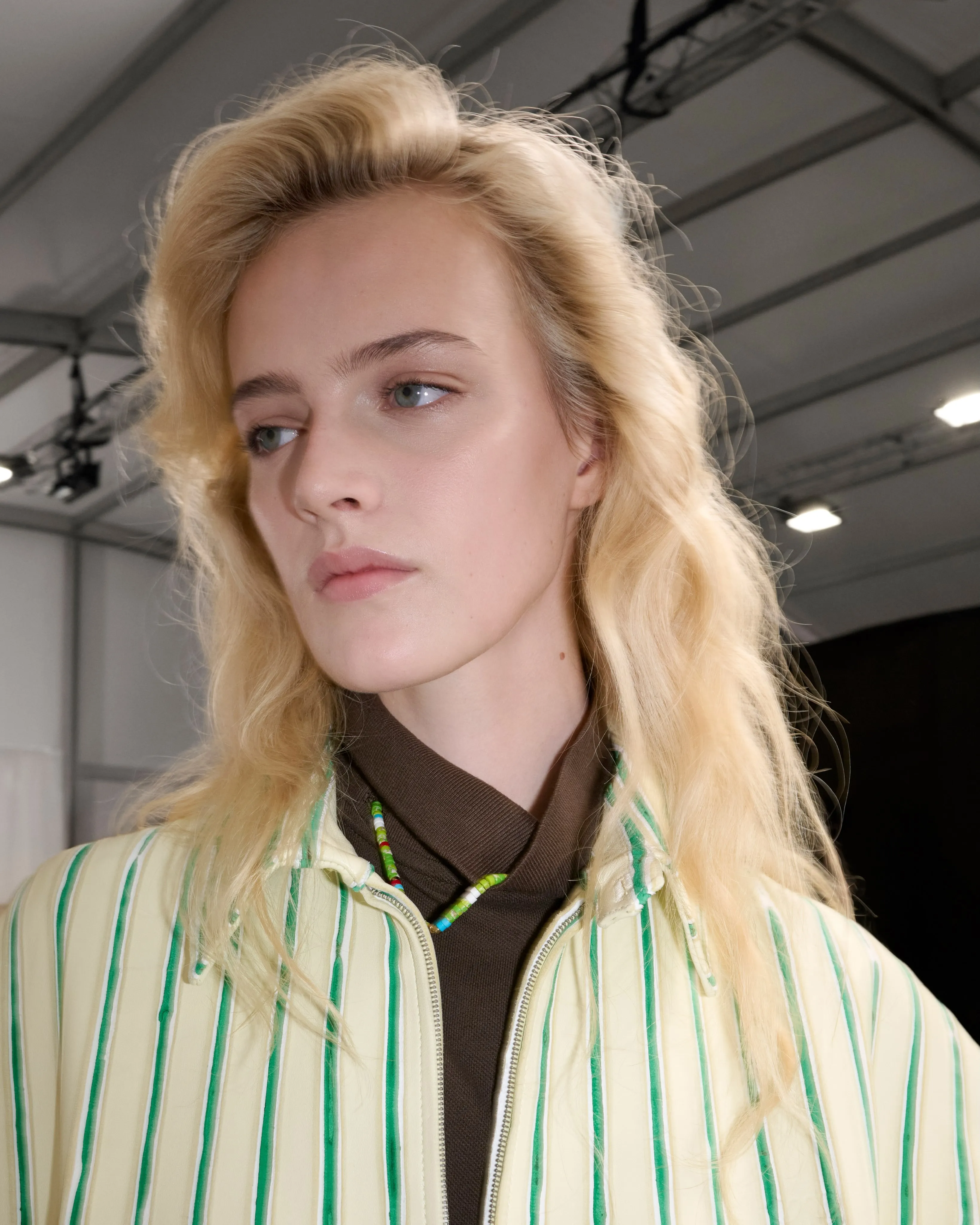 Textural detail of light knit meeting unexpected resin collar element