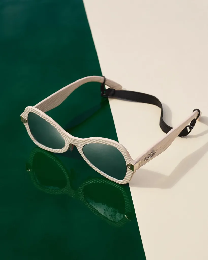 Model displaying curved ivory frames evoking the kinetic spirit of the Spring-Summer 2027 collection