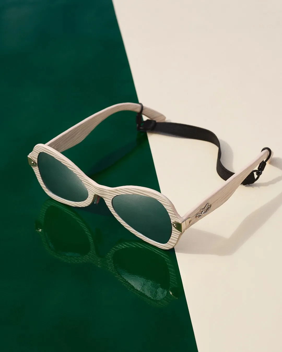Model displaying curved ivory frames evoking the kinetic spirit of the Spring-Summer 2027 collection