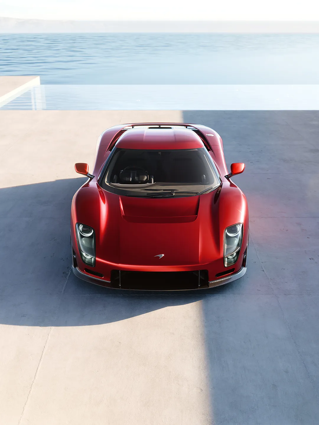 McLaren 6GT side profile showcasing continuous sculptural bodywork in high-metallic red