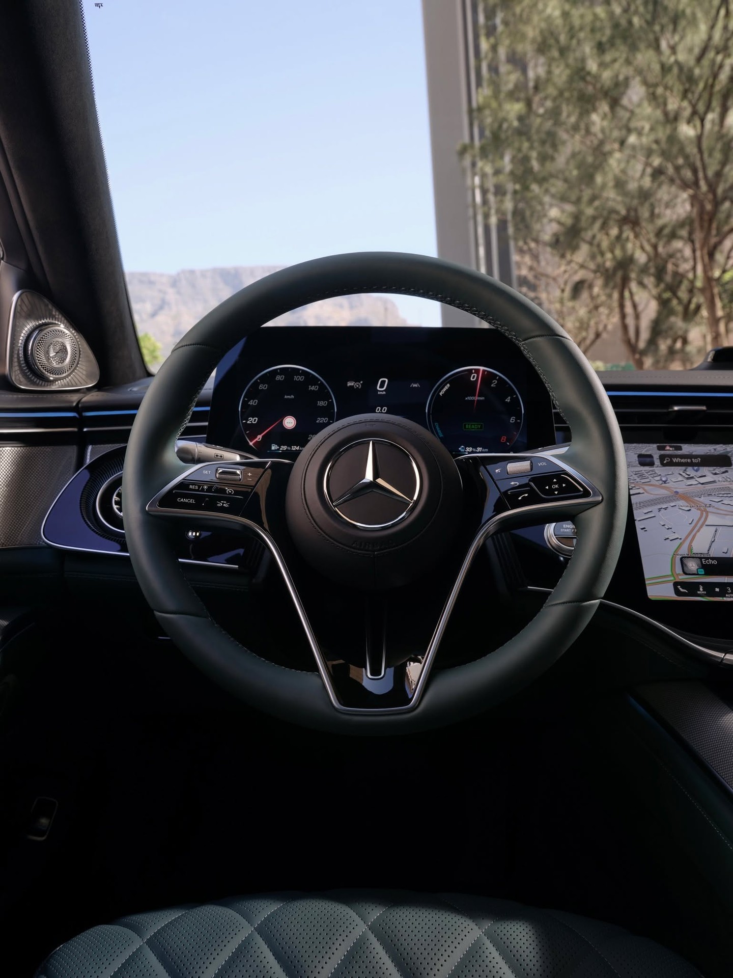 Illuminated Mercedes-Benz three-pointed star emblem glowing softly on luxury automobile