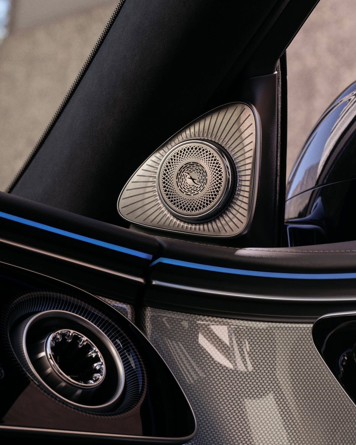 Mercedes-Benz vehicle featuring the illuminated emblem in evening light, showcasing modern luxury