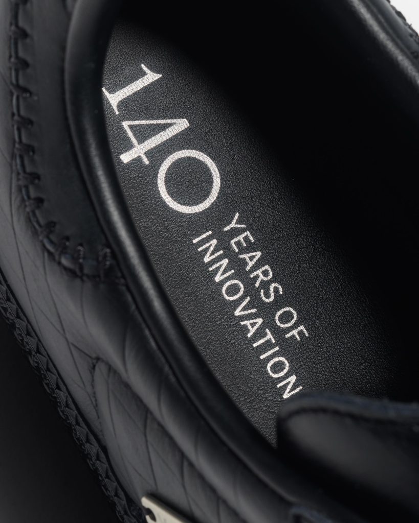 Detail of the Adidas branding and Mercedes-Benz partnership elements
