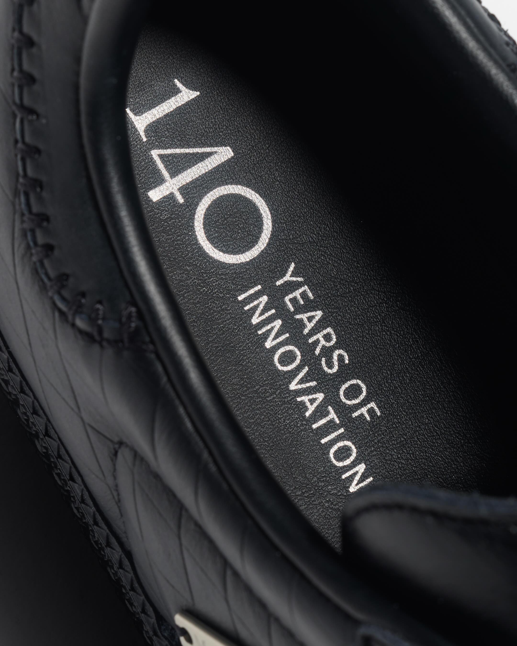 Detail of the Adidas branding and Mercedes-Benz partnership elements