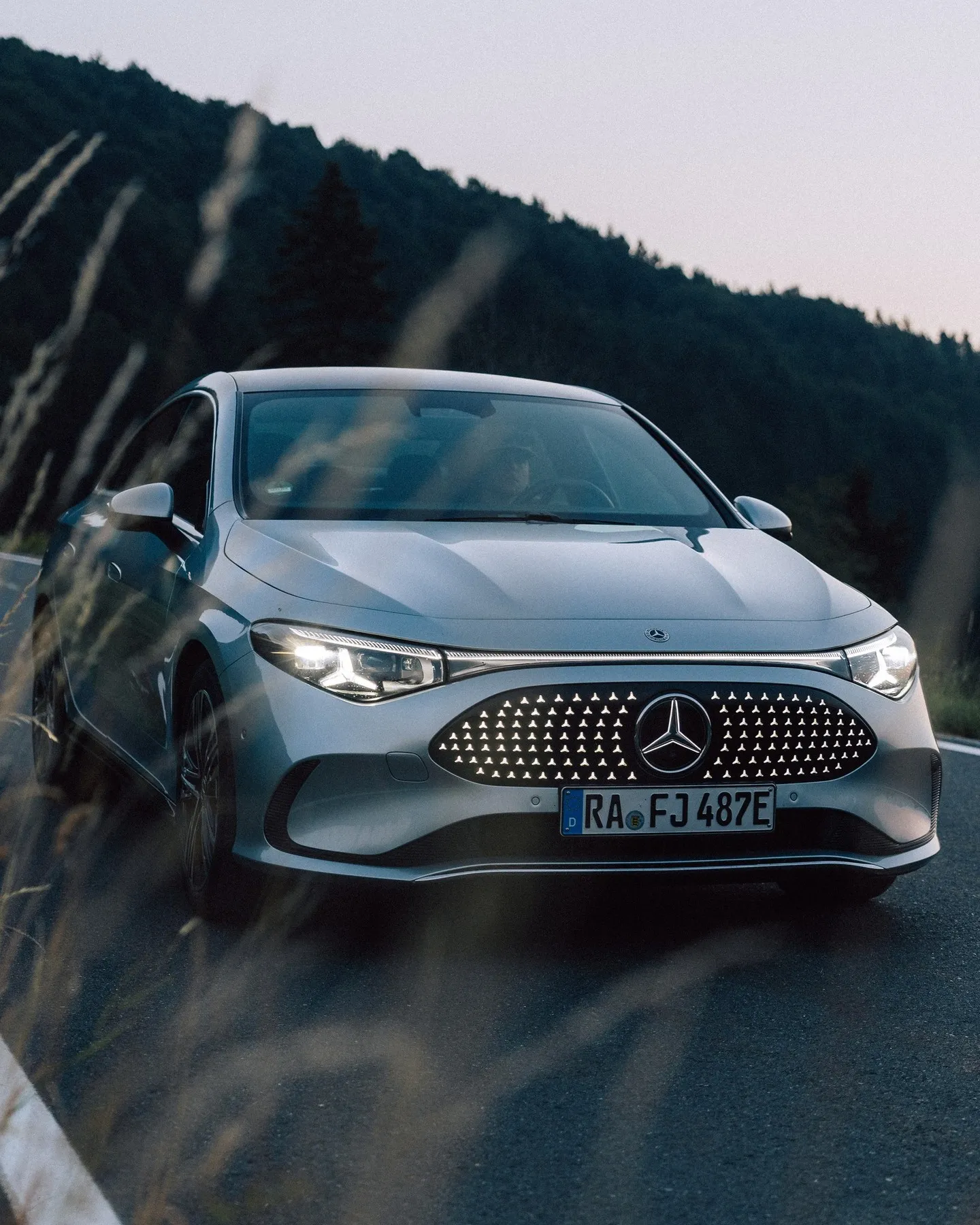 Side profile of the Mercedes-Benz CLA highlighting its graceful proportions during twilight hours