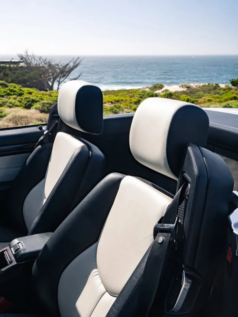 The iconic SL 500 positioned along a sun-drenched coastline with sea views in the distance