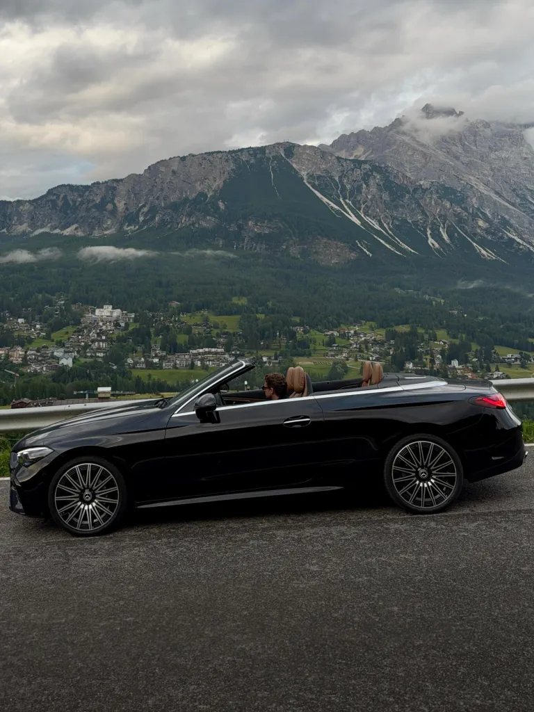 Side profile of the CLE Cabriolet highlighting its graceful proportions against alpine backdrop