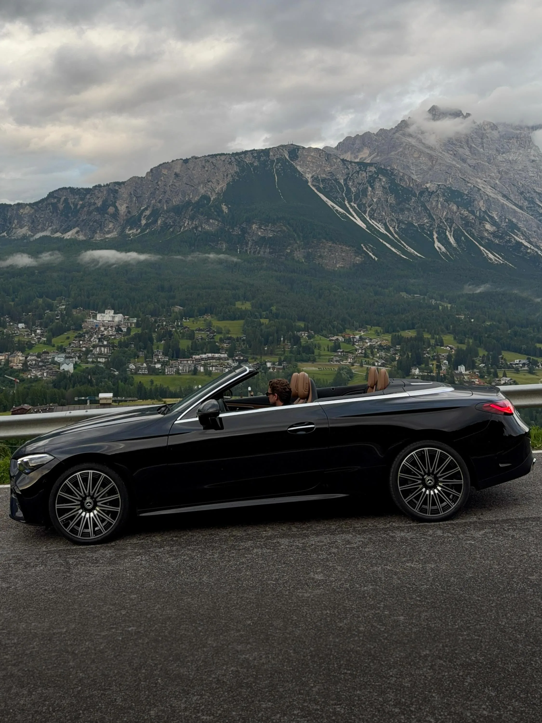 Side profile of the CLE Cabriolet highlighting its graceful proportions against alpine backdrop