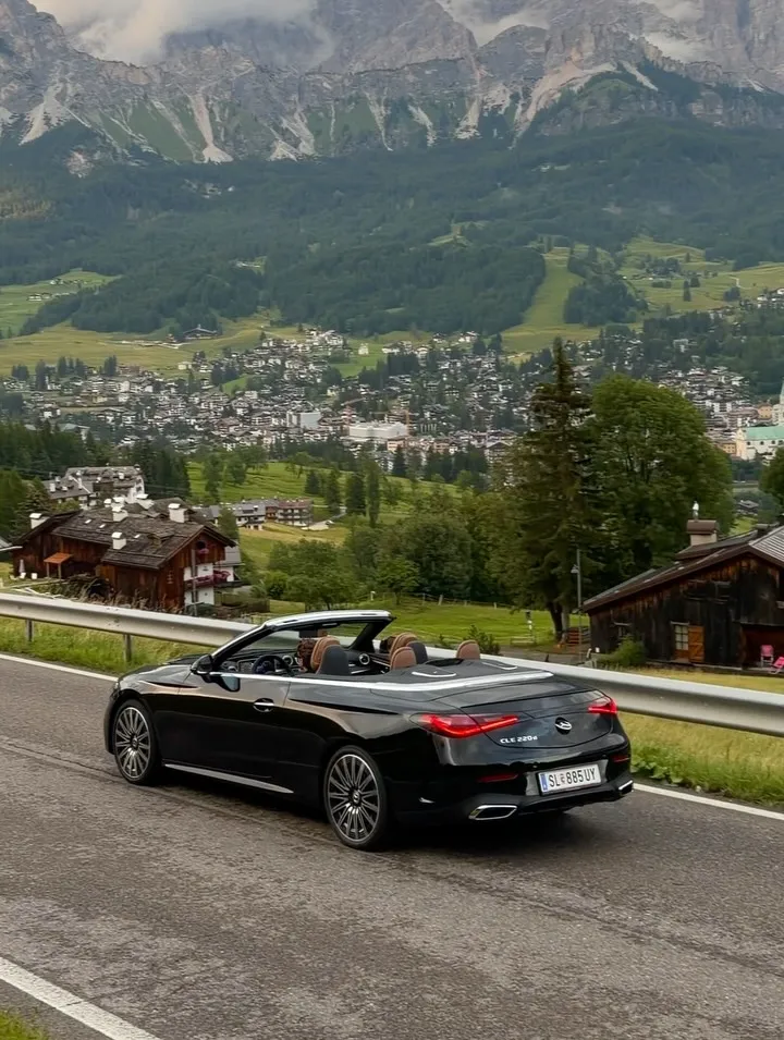 Rear view of the convertible with the mountain horizon and dramatic landscape composition