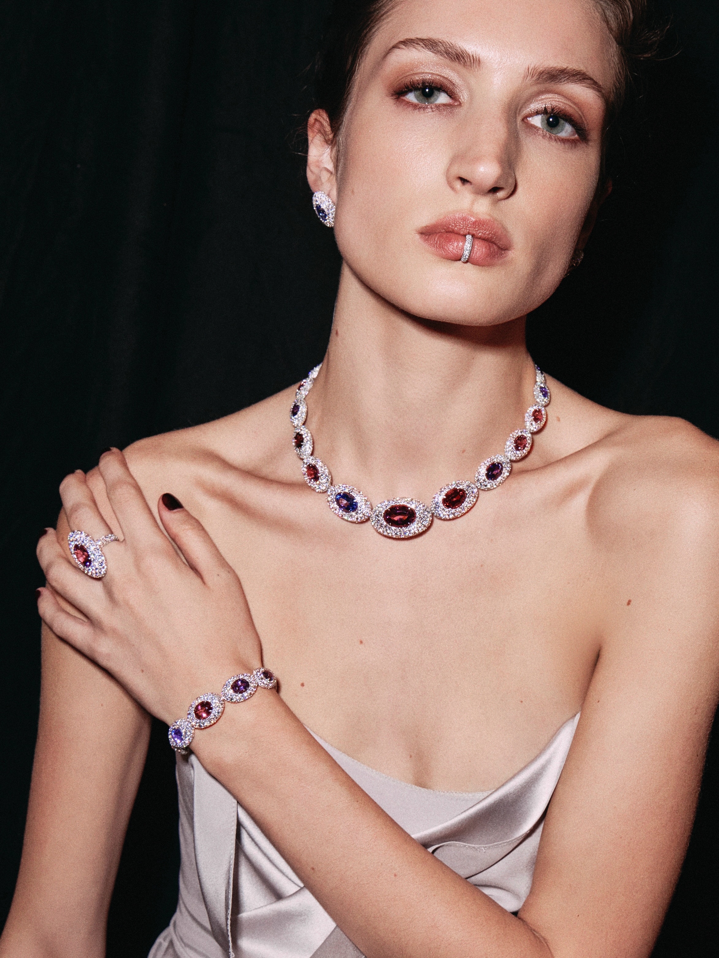Model adorned with bold coloured gemstone earrings from Messika High Jewelry 2026 collection