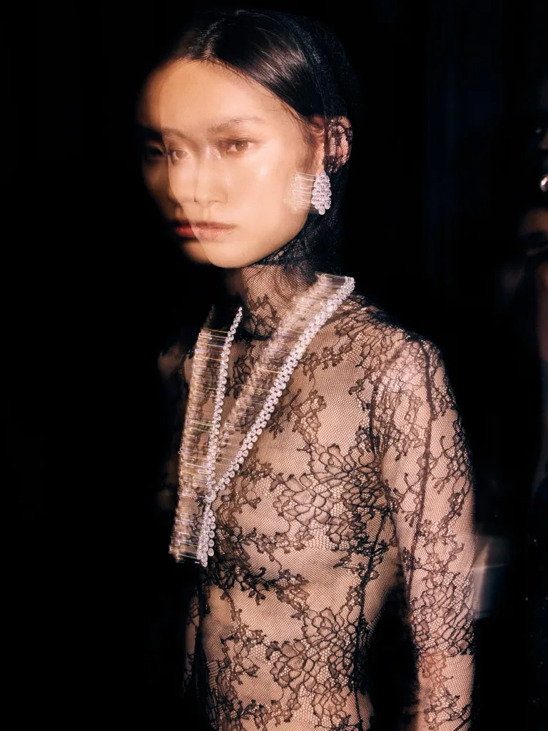 Valérie Messika engages with her models in an intimate backstage moment before the presentation