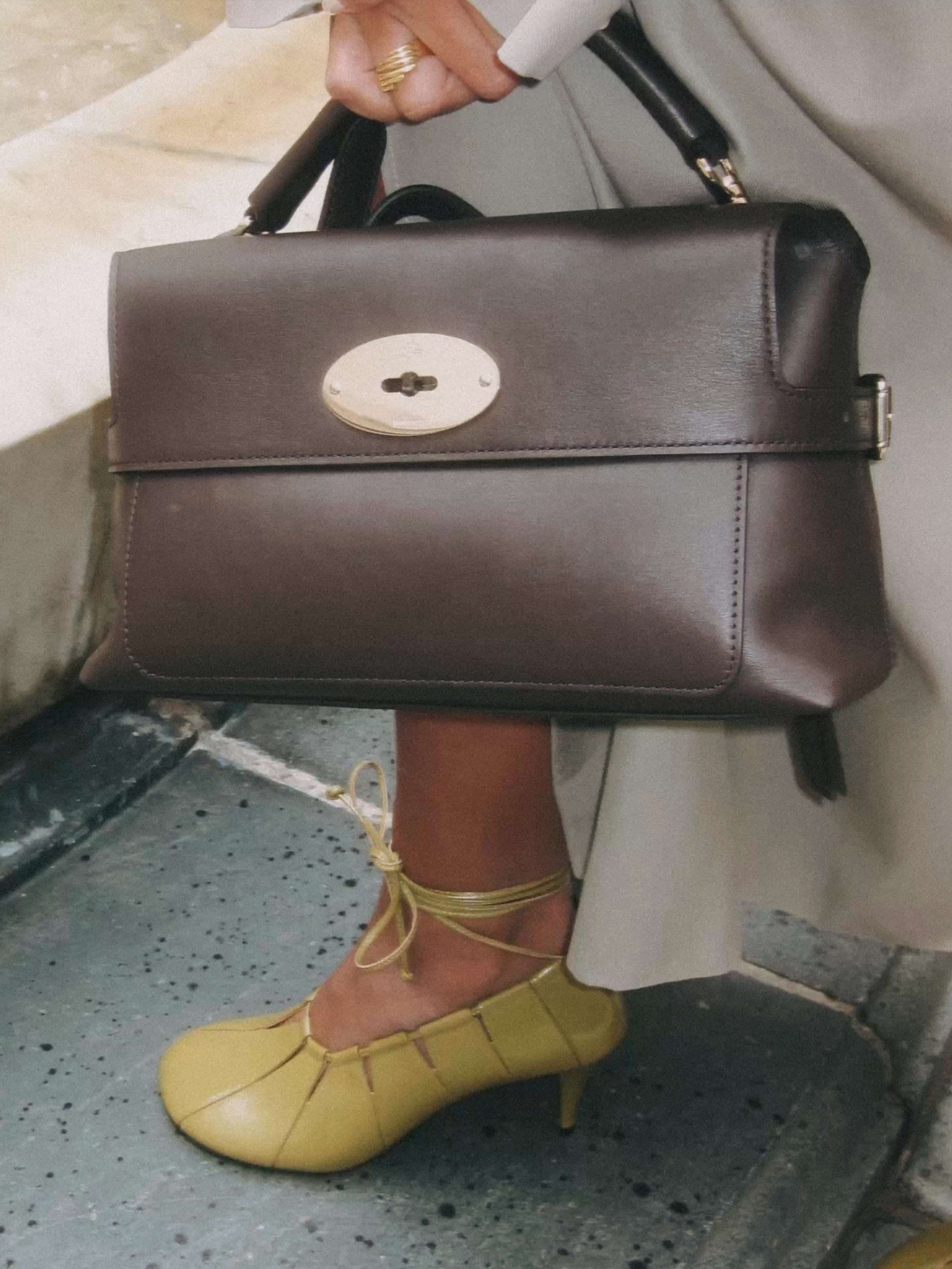 Stevie Top Handle bag in deep Ebony leather showcasing the elegant proportions and crafted handle