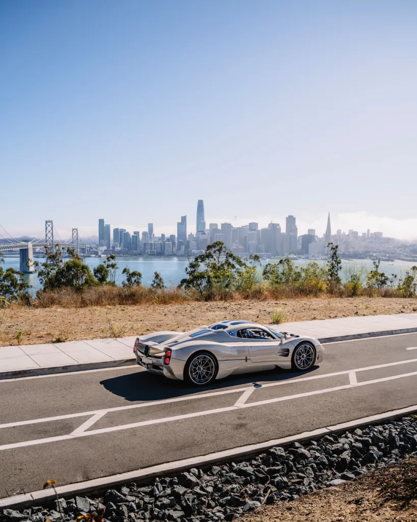 Pagani Utopia Coupé captured against San Francisco's urban landscape, emphasizing automotive artistry and engineering excellence