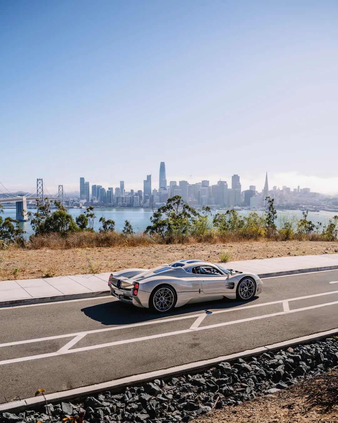 Pagani Utopia Coupé captured against San Francisco's urban landscape, emphasizing automotive artistry and engineering excellence