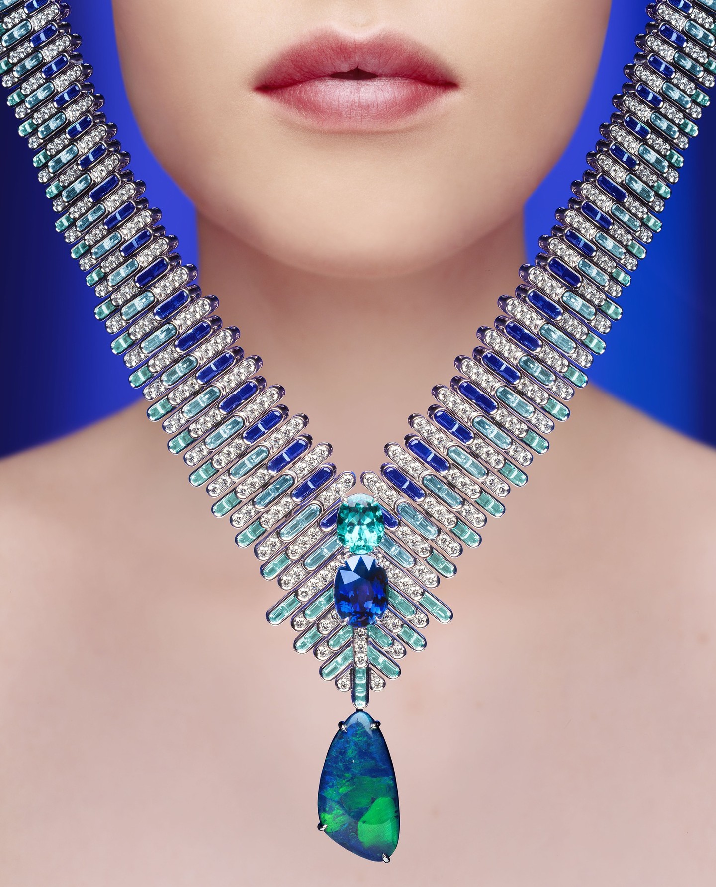A sculptural High Jewellery necklace by Piaget featuring deep blue sapphires, aquamarines, tourmalines, black opal and diamonds arranged in flowing lines