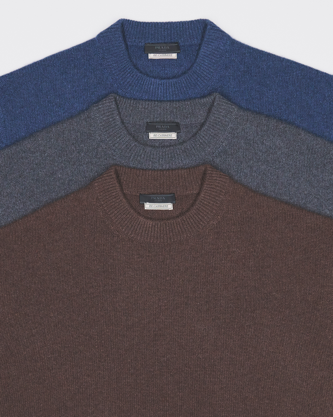 Serene studio composition featuring Prada Re-Cashmere and Re-Wool pieces in neutral tones