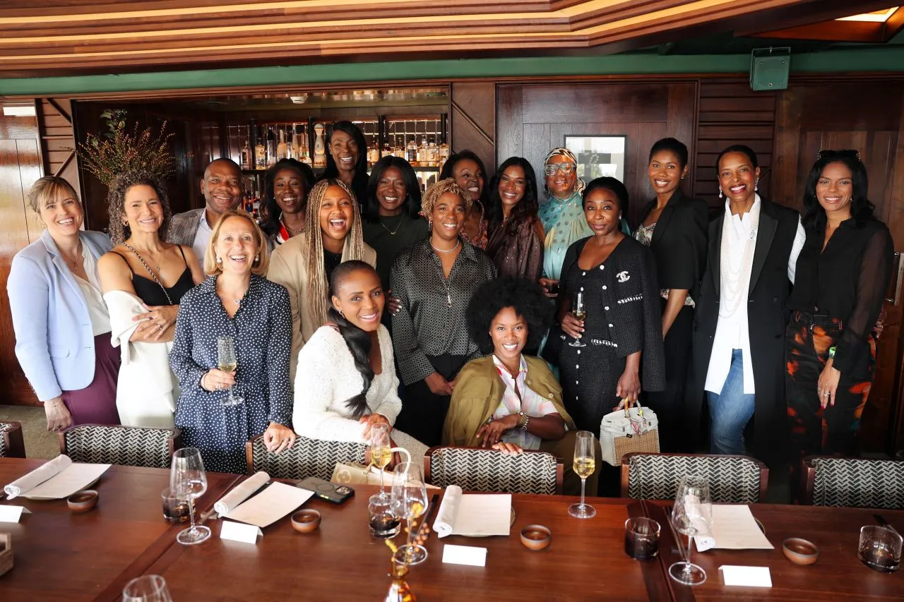 Ruth Bussey and Karen Cummings-Palmer with assembled entrepreneurs at the Black History Month celebration