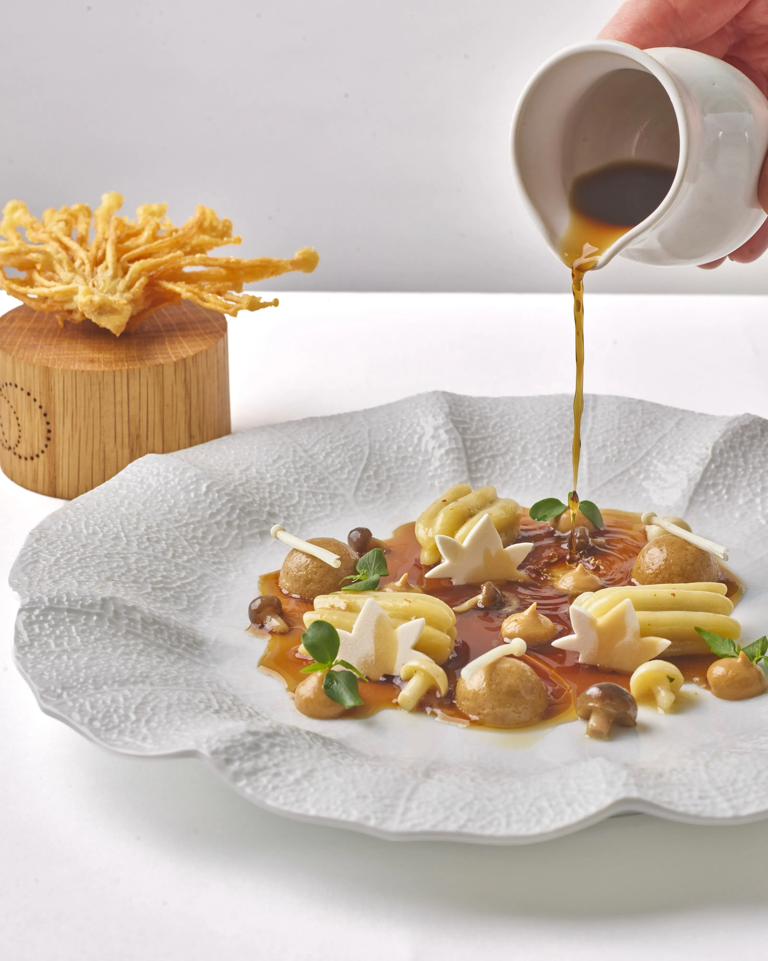 Zucca pasta Forestière plated with mushroom consommé, Tahoon cress and enoki tempura at Restaurant Daniel