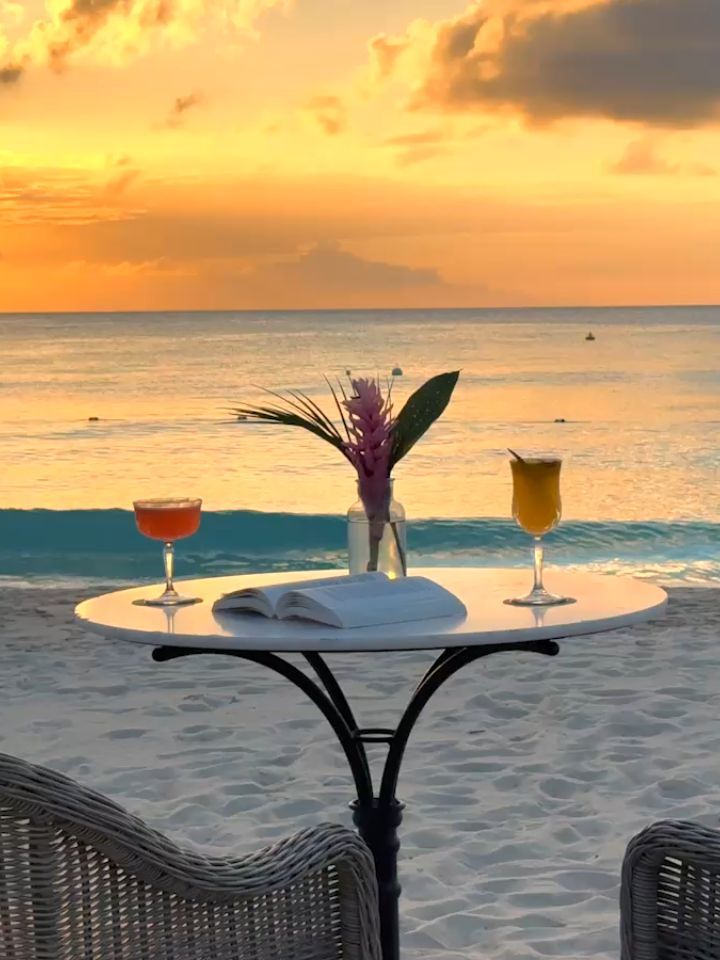 Golden hour sunset view from the resort with warm light illuminating the pristine beach
