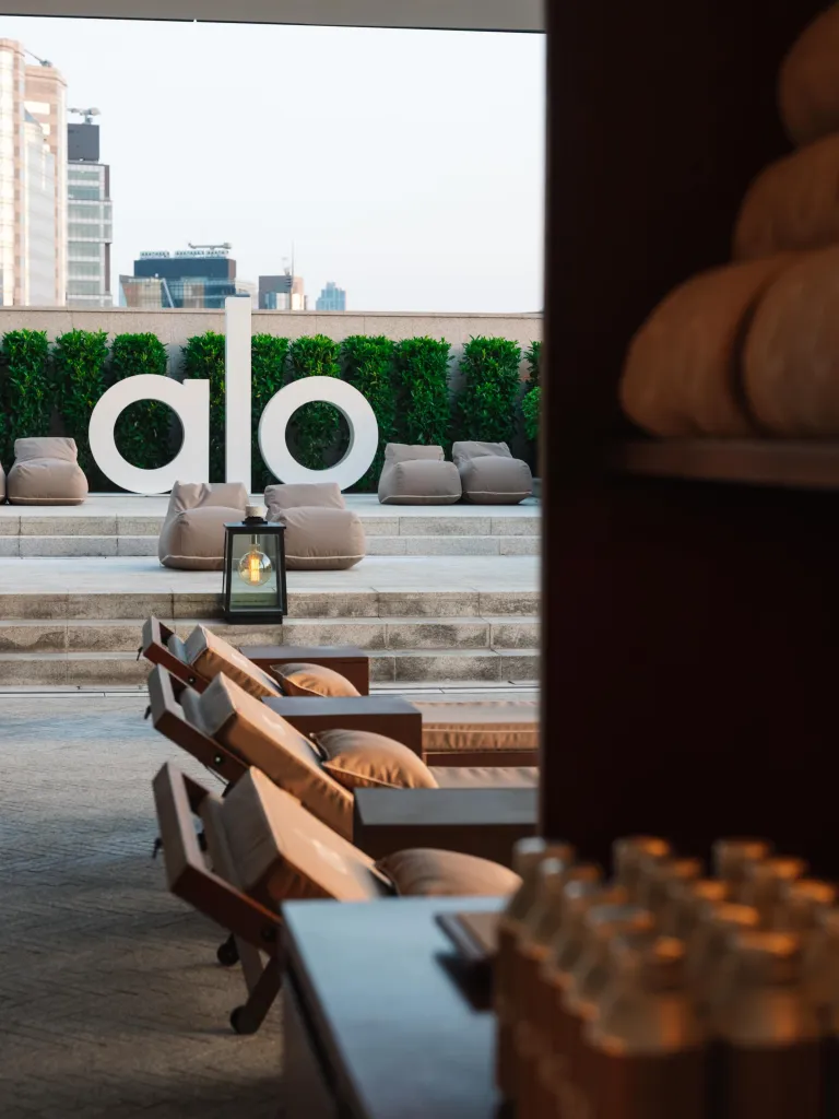 Asaya wellness pool reimagined with Alo's signature gravel aesthetic and poolside wellness setting at Rosewood Hong Kong