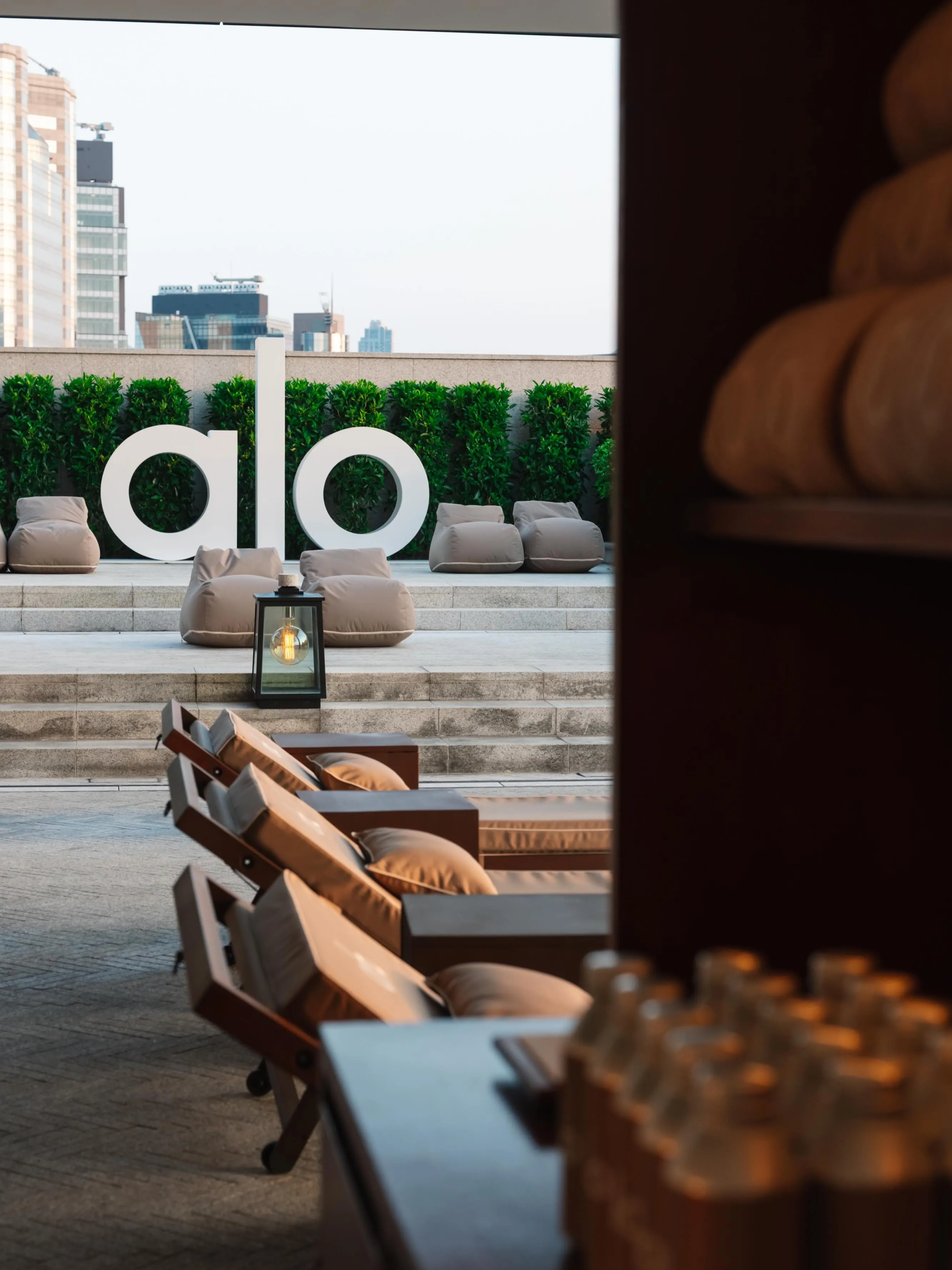 Asaya wellness pool reimagined with Alo's signature gravel aesthetic and poolside wellness setting at Rosewood Hong Kong