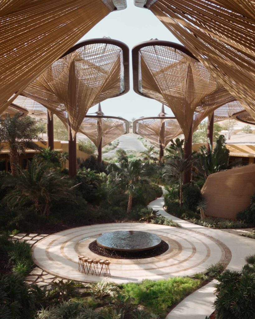 Traditional Arabic architectural details with warm adobe tones and intricate geometric patterns at the resort