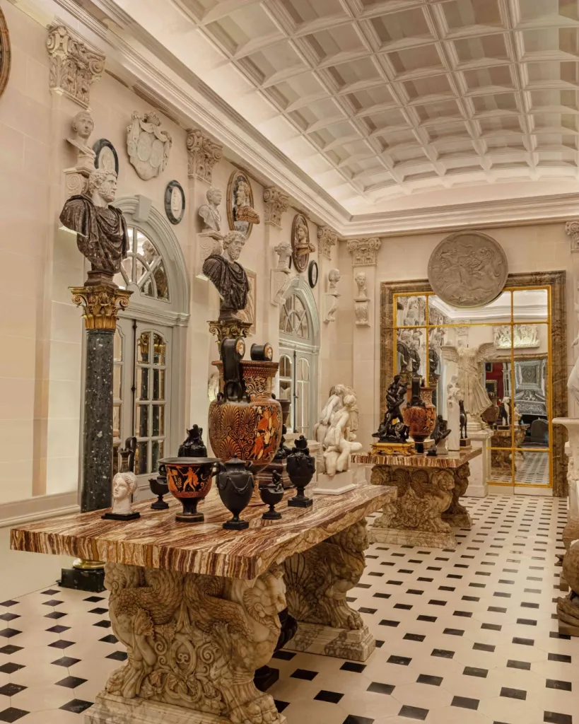 Historic hôtel particulier room featuring monumental paintings and refined furnishings