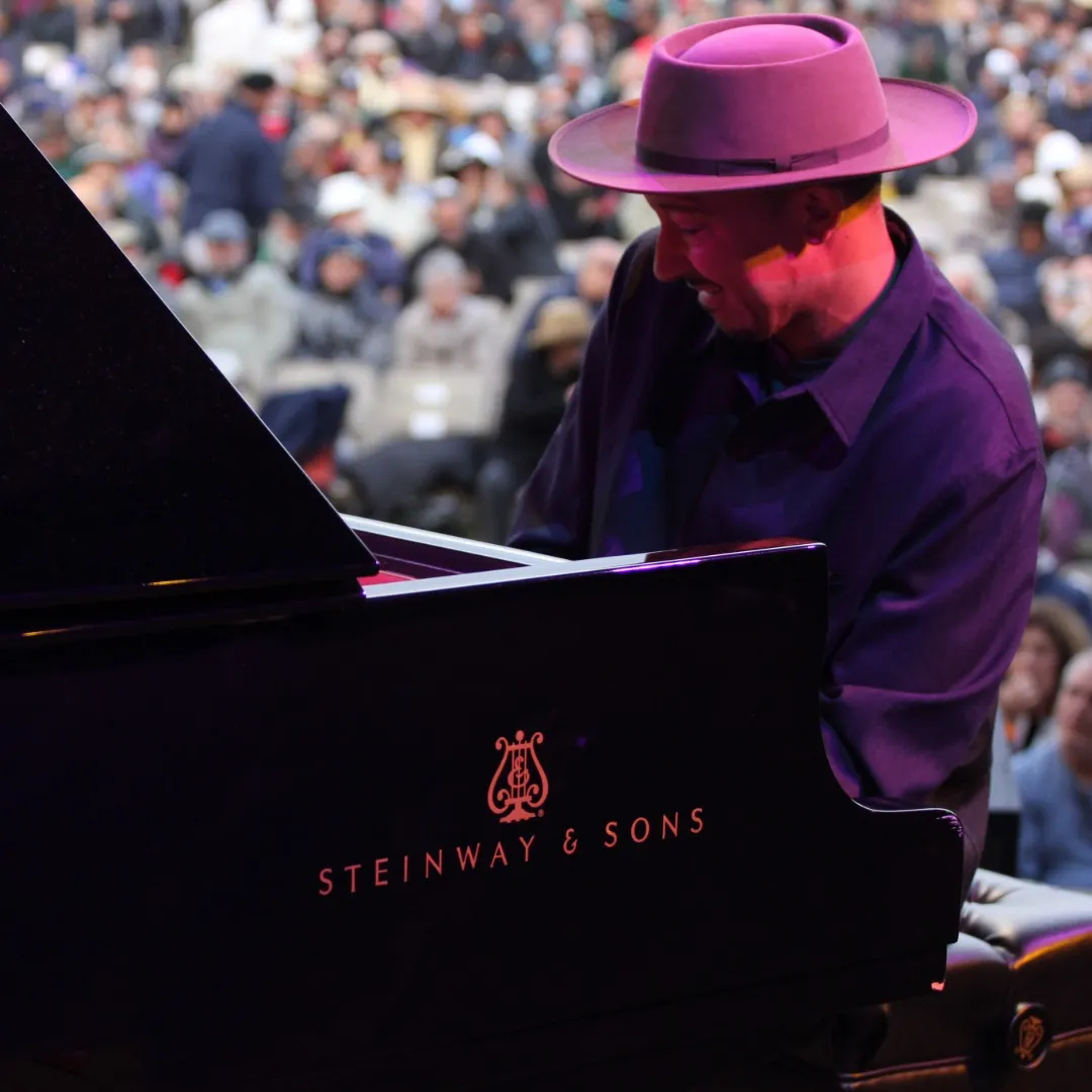 Pianist Gerald Clayton performing on a Steinway Model D grand piano at the Monterey Jazz Festival