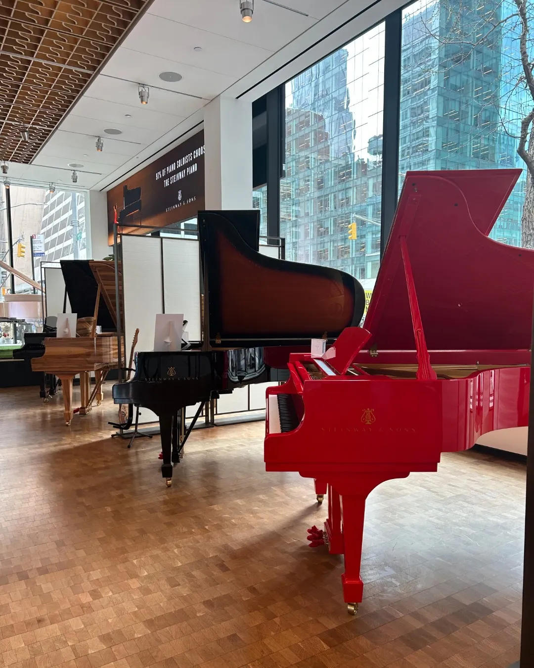 The elegant interior of Steinway Hall in New York City, featuring a grand piano in a refined retail showroom setting