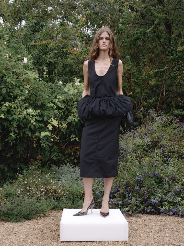 Close detail of the Appaloosa wristlet in Italian-crafted vegan leather alternative, paired with the Summer 2027 dress