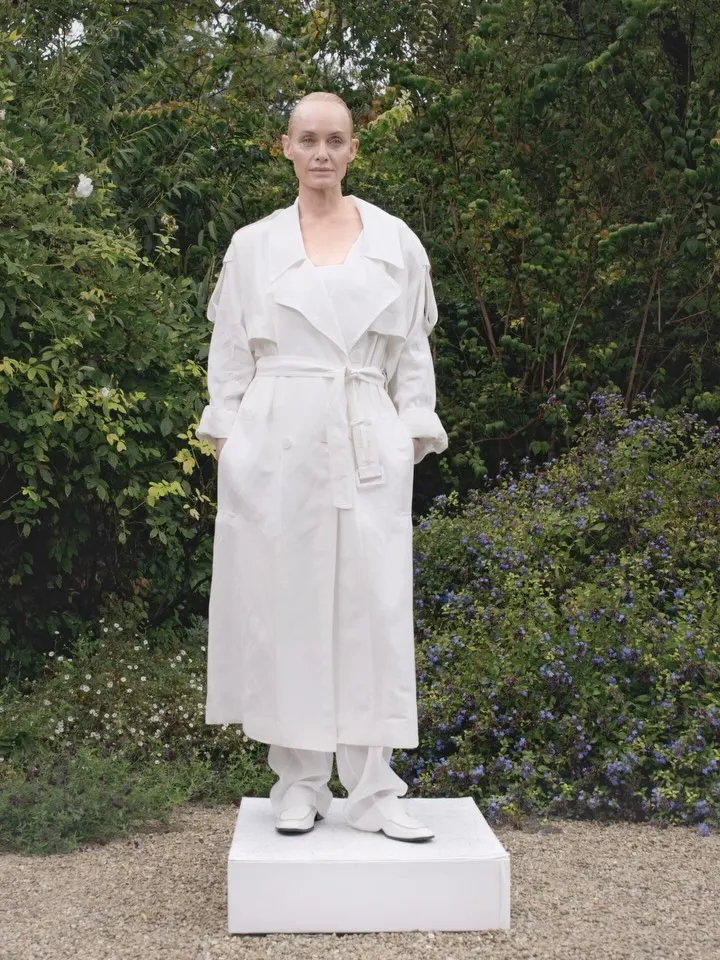 Close detail of the technical cotton trench showcasing sustainable fabric construction and refined tailoring