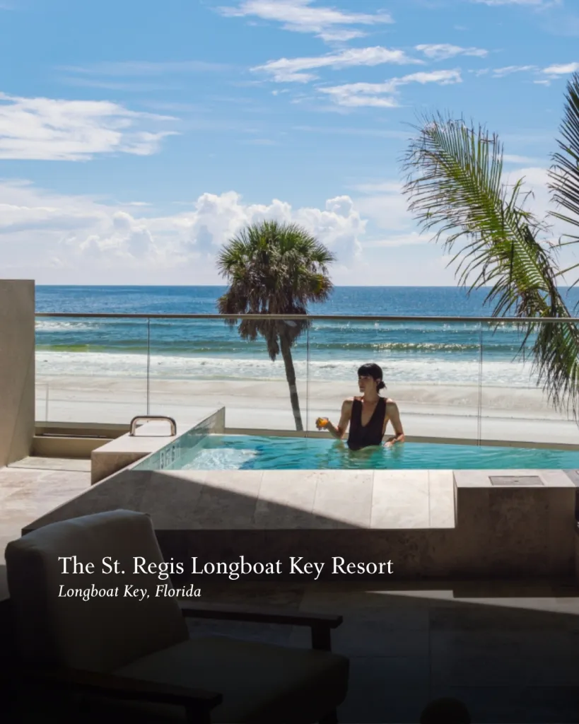 Luxury beachfront resort with elegant architecture overlooking pristine white sand beach