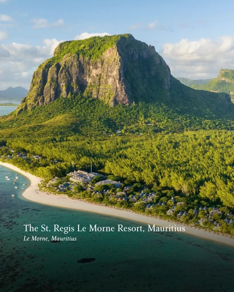 Coastal luxury resort nestled against dramatic cliffs and turquoise ocean backdrop