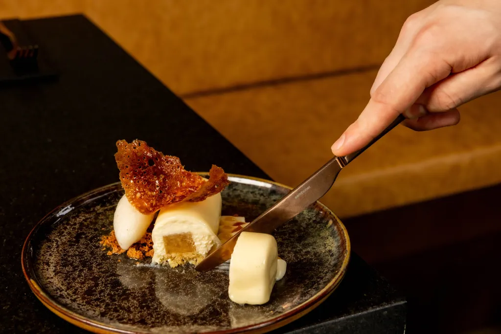 Overhead composition showcasing the layered elements and refined presentation of the spiced pear dessert